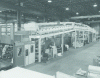 Figure 28 - Coating machine for pressure-sensitive adhesives (left: glue roller system, above: heat-drying tunnel) (source: Faustel Inc.)