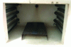 Figure 7 - Thermal degradation/decomposition of
tensile specimens under isothermal conditions: tensile specimen placed
on a metal grid to ensure homogeneous temperature distribution in
a muffle furnace