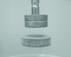 Figure 4 - YBaCuO pellet suspended under a permanent magnet (source: CNRS/CRETA – Laboratoire de Cristallographie) 