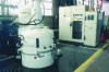 Figure 15 - Vertical vacuum furnace. In the background, the control cabinet