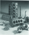 Figure 7 - Typical automotive engine parts (cylinder head, cylinder block in lamellar graphite cast iron, camshaft cast on coolers and crankshaft in spheroidal graphite cast iron)