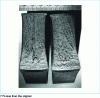 Figure 20 - Static tearing of a 25 mm plate (Van der Veen test). Left: split mild steel plate divided in two by internal stress. Parabolic stop of the internal brittle zone (see figure ).