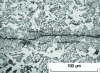 Figure 51 - Cracks connecting sulfide inclusions elongated by rolling. 35 mm TM microalloyed mild steel sheet. Needled bainite + sulfide, ferrite in white, pearlite in black, HV10 = 350 in segregated fiber.