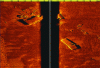 Figure 18 - Example of side scan sonar acquisition (4200: Multi-Purpose Survey System from EdgeTech). A black band can be seen in the center separating the images from the two side beams. This band corresponds to the sound path in open water (i.e. without echo) before the first bottom echo appears. The image shows a wreck and debris. The shadows provide information on the height of the debris (credit: Image courtesy of EdgeTech).