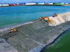Figure 6 - Reuse of pebbles excavated from future navigation channels to build Port 2000 dikes (credit GPMH).