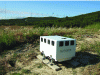 Figure 52 - Leosphère's WindCube™ compact lidar system, in operation alongside a conventional measurement mast for a Spanish EHN park (credit: Leosphère).