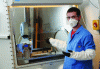 Figure 1 - Illustration of powder handling under extraction using PPE (goggles, mask, gloves, smock and sleeves).