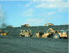 Figure 8 - Mining the spoil heaps using hydraulic shovels, dumpers and CAT 631 type scrapers pushed by CAT D.10 type bulldozers (Razel photo library).