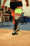 Figure 1 - Photograph of a transtibial amputee walking with his prosthetic device during recording with a passive marker optoelectronic system.