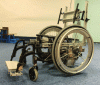 Figure 5 - Photograph of an instrumented wheelchair (FRET-2) enabling measurement of mechanical action torsorsors on the two handrails, seat, backrest and footrest.
